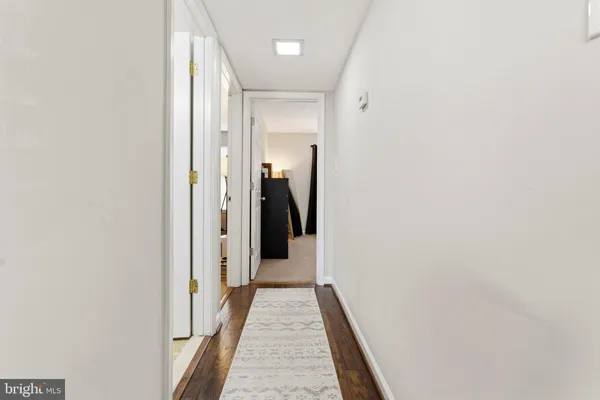 a view of hallway with wooden floor