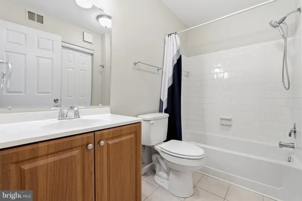 a bathroom with a sink a toilet and a large mirror