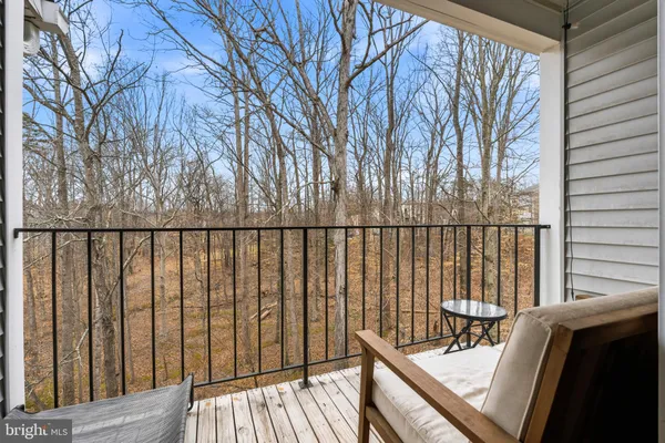 a view of balcony with wooden floor and fence