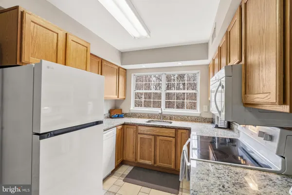 a kitchen with a refrigerator a sink and a stove
