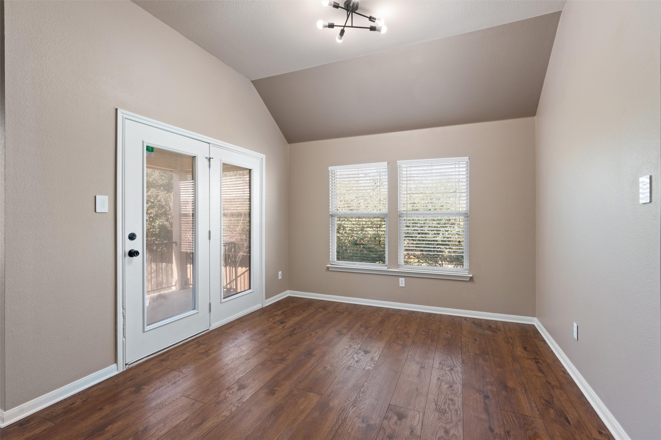 407 Red Hawk Drive Leander, TX 78641 - Photo 14 of 34 an empty room with wooden floor and windows