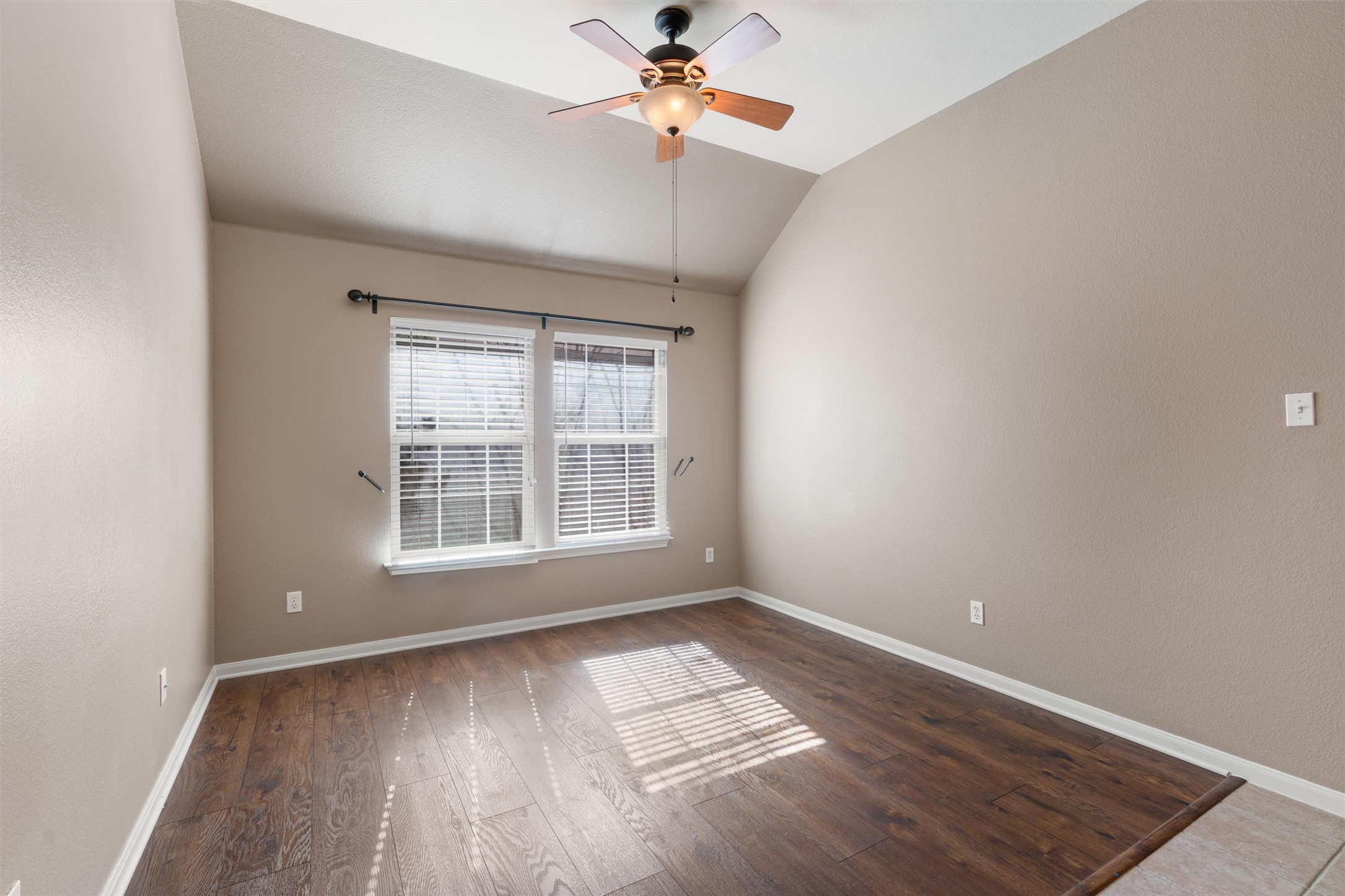 407 Red Hawk Drive Leander, TX 78641 - Photo 6 of 34 an empty room with wooden floor and windows