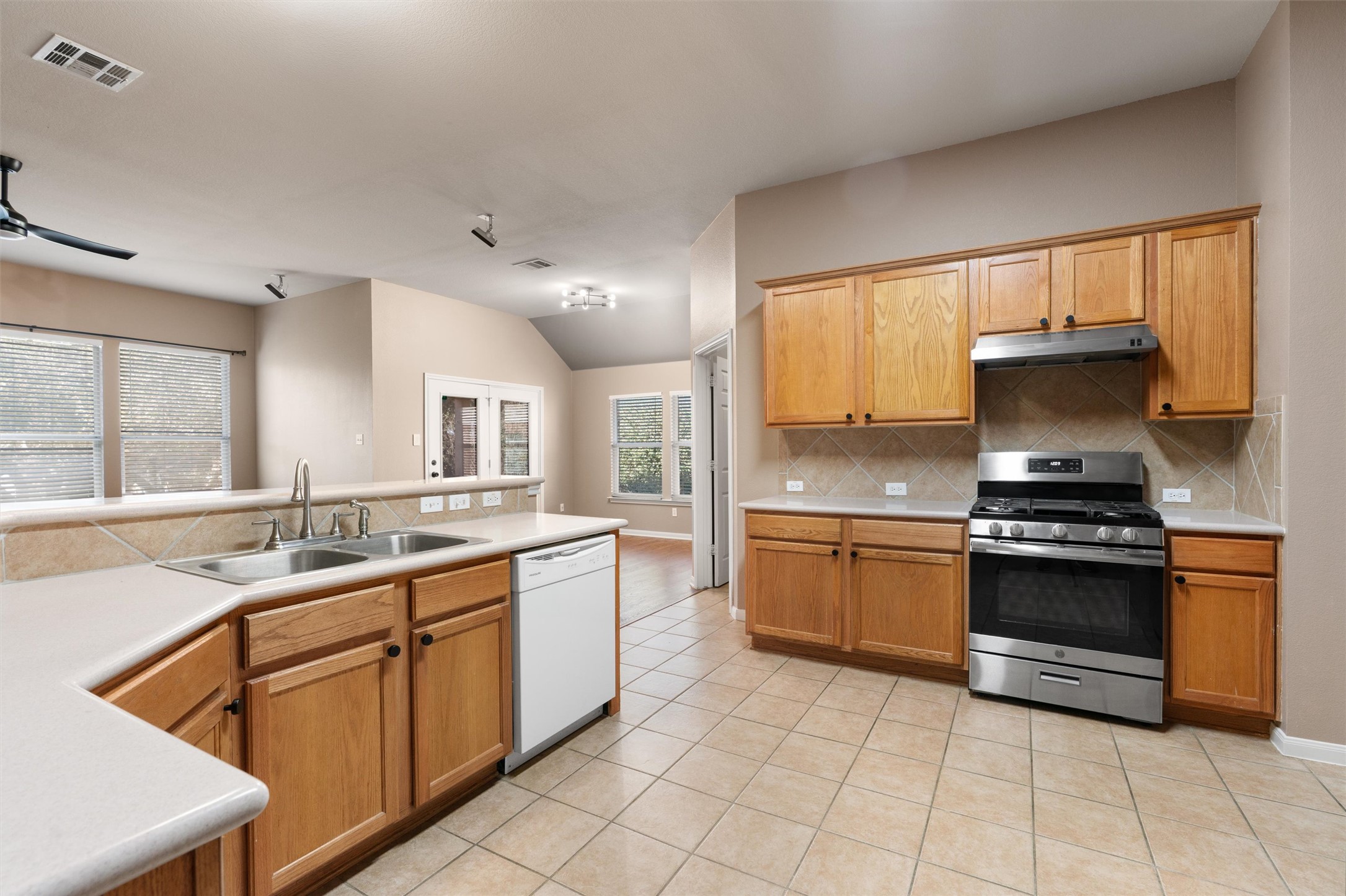 407 Red Hawk Drive Leander, TX 78641 - Photo 9 of 34 a kitchen with a sink stove and cabinets
