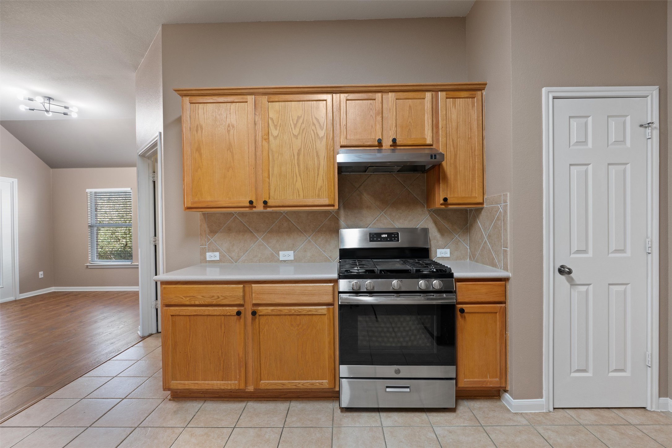407 Red Hawk Drive Leander, TX 78641 - Photo 10 of 34 a kitchen with a stove and a microwave
