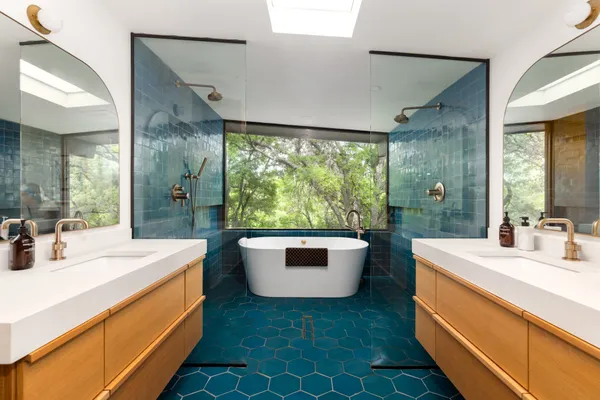 a spacious bathroom with a sink a mirror and a shower