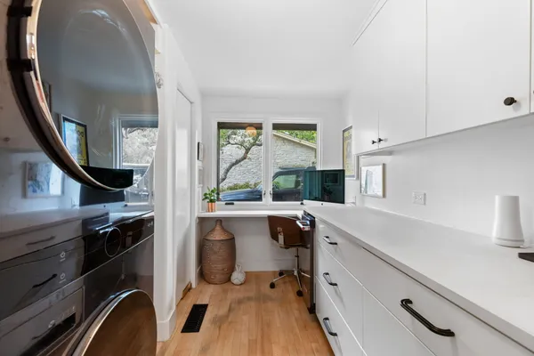 a spacious bathroom with a double vanity sink a large mirror and a bathtub
