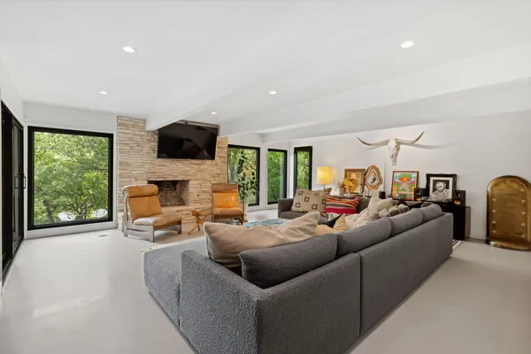 a living room with furniture fireplace and flat screen tv