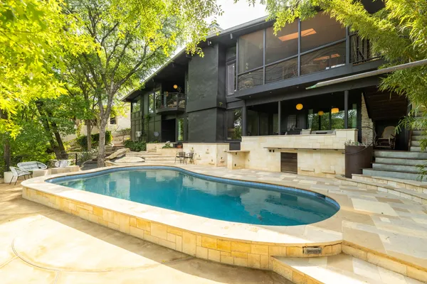a view of a swimming pool with outdoor seating