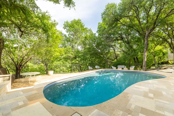 a view of swimming pool with a patio