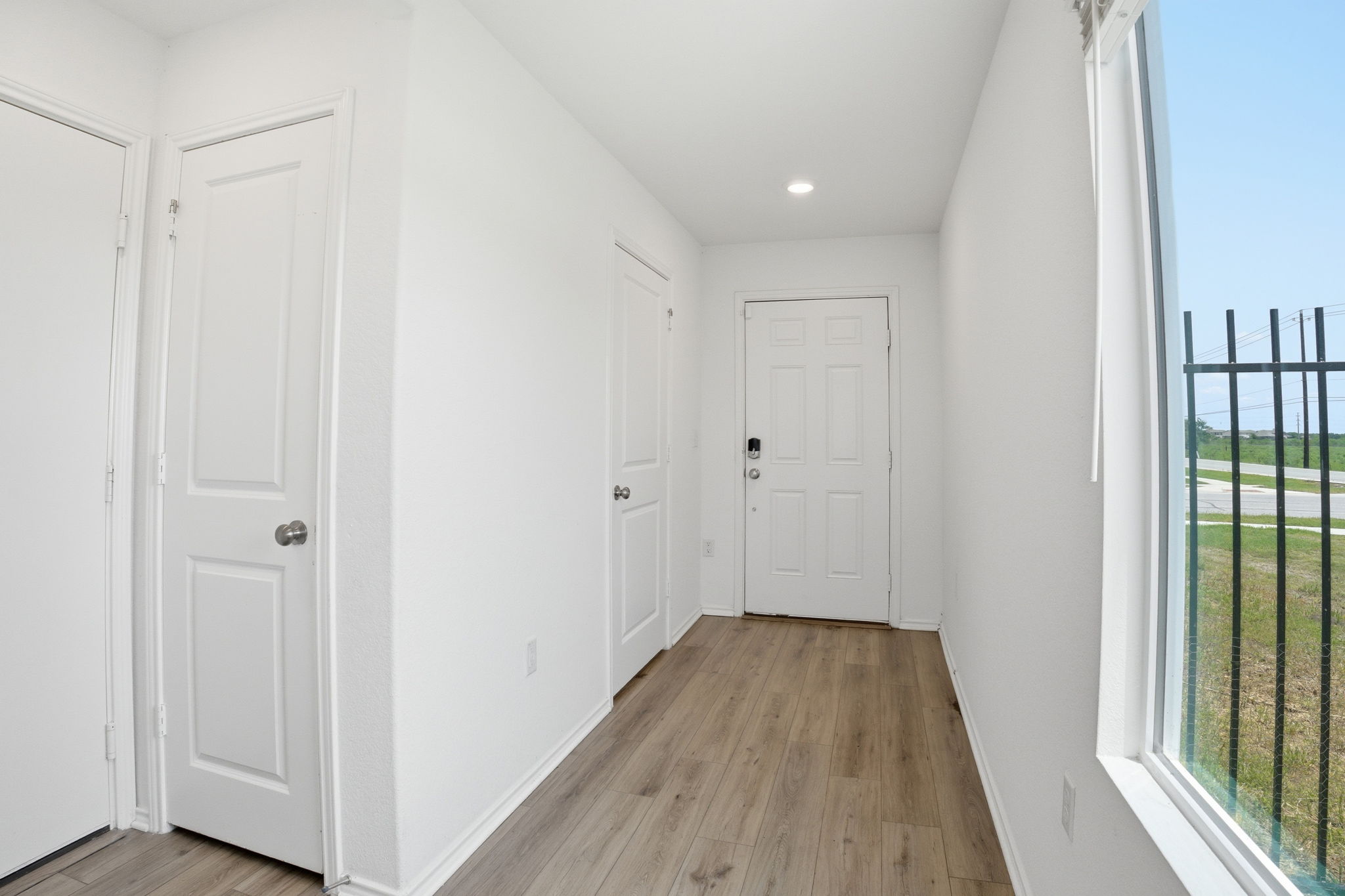 12213 Rising Moon Lane Del Valle, TX 78617 - Photo 16 of 19 a view of a hallway with wooden floor