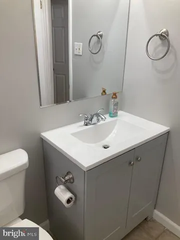 a bathroom with a sink toilet and mirror