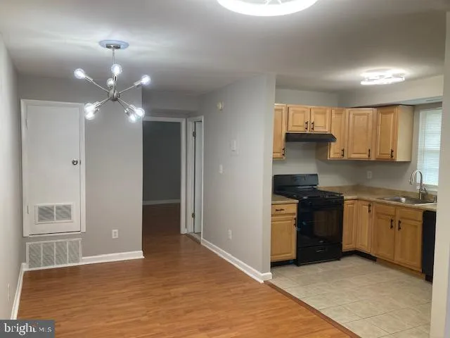 a kitchen with stainless steel appliances granite countertop a stove and a refrigerator