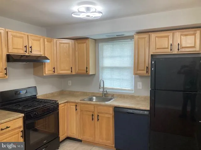 a kitchen with a stove and a refrigerator