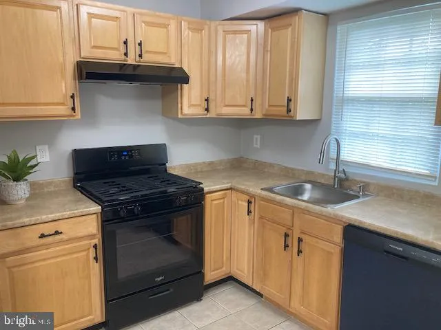 a kitchen with stainless steel appliances granite countertop white cabinets and a stove