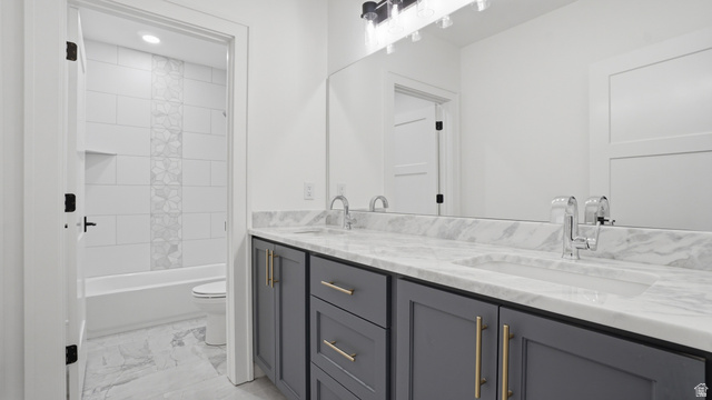 1682 North 1950 W Street, Unit 9 Provo, UT 84604 - Photo 52 of 84 Double vanity with marble-finish countertop and integrated sinks, featuring gray cabinetry with gold-tone hardware