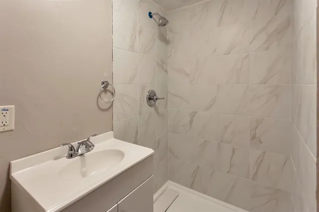 a bathroom with a sink a mirror and shower