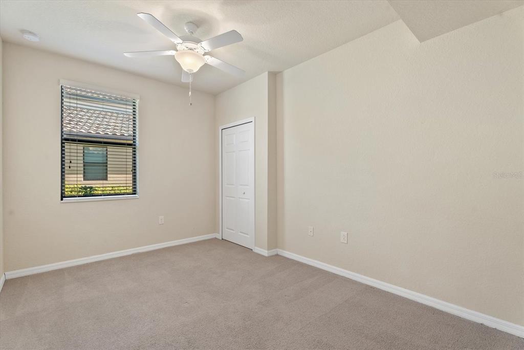 20080 Ragazza Circle, Unit 102 Venice, FL 34293 - Photo 28 of 49 an empty room with windows and fan