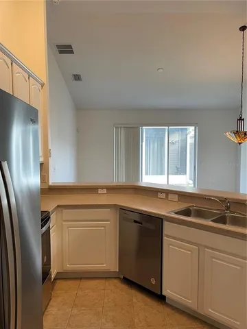 a kitchen with a sink stove and refrigerator