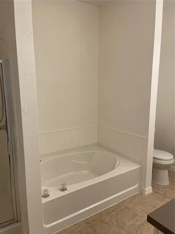 a white bath tub sitting next to a white toilet