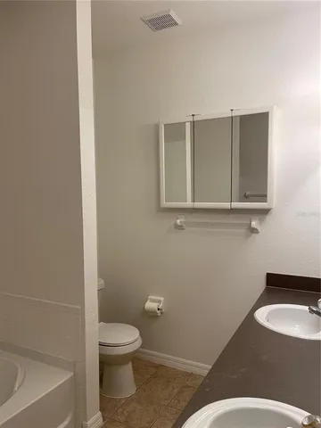 a bathroom with a toilet a sink and bathtub