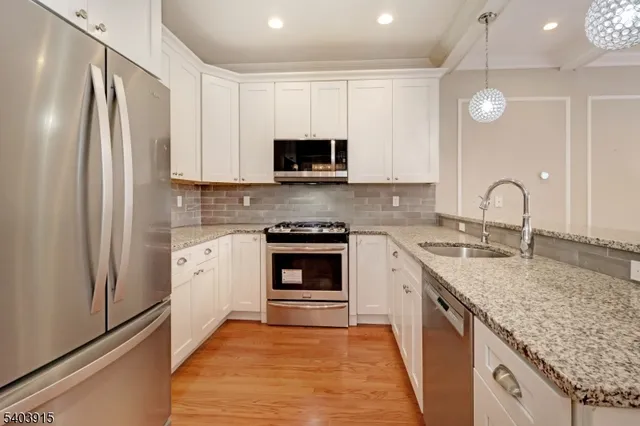 a kitchen with a sink stove and refrigerator