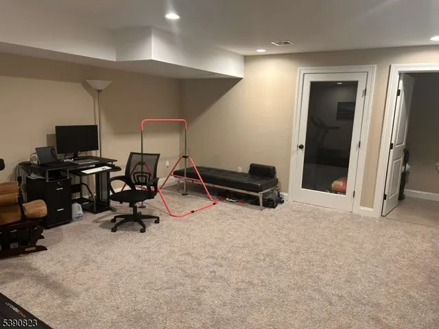 a view of a workspace with furniture and a window