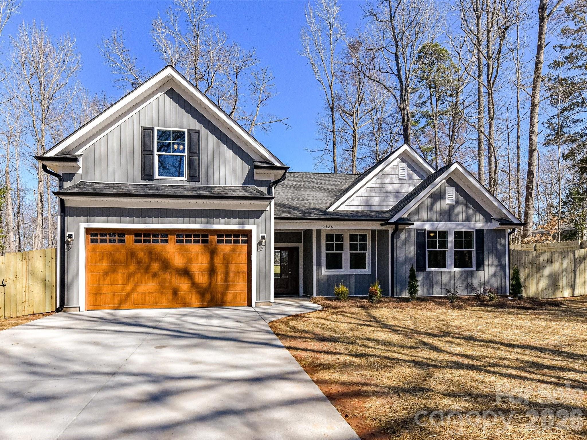 104 Poplar Street Clover, SC 29710 - Photo 1 of 33 a front view of a house with a yard and garage