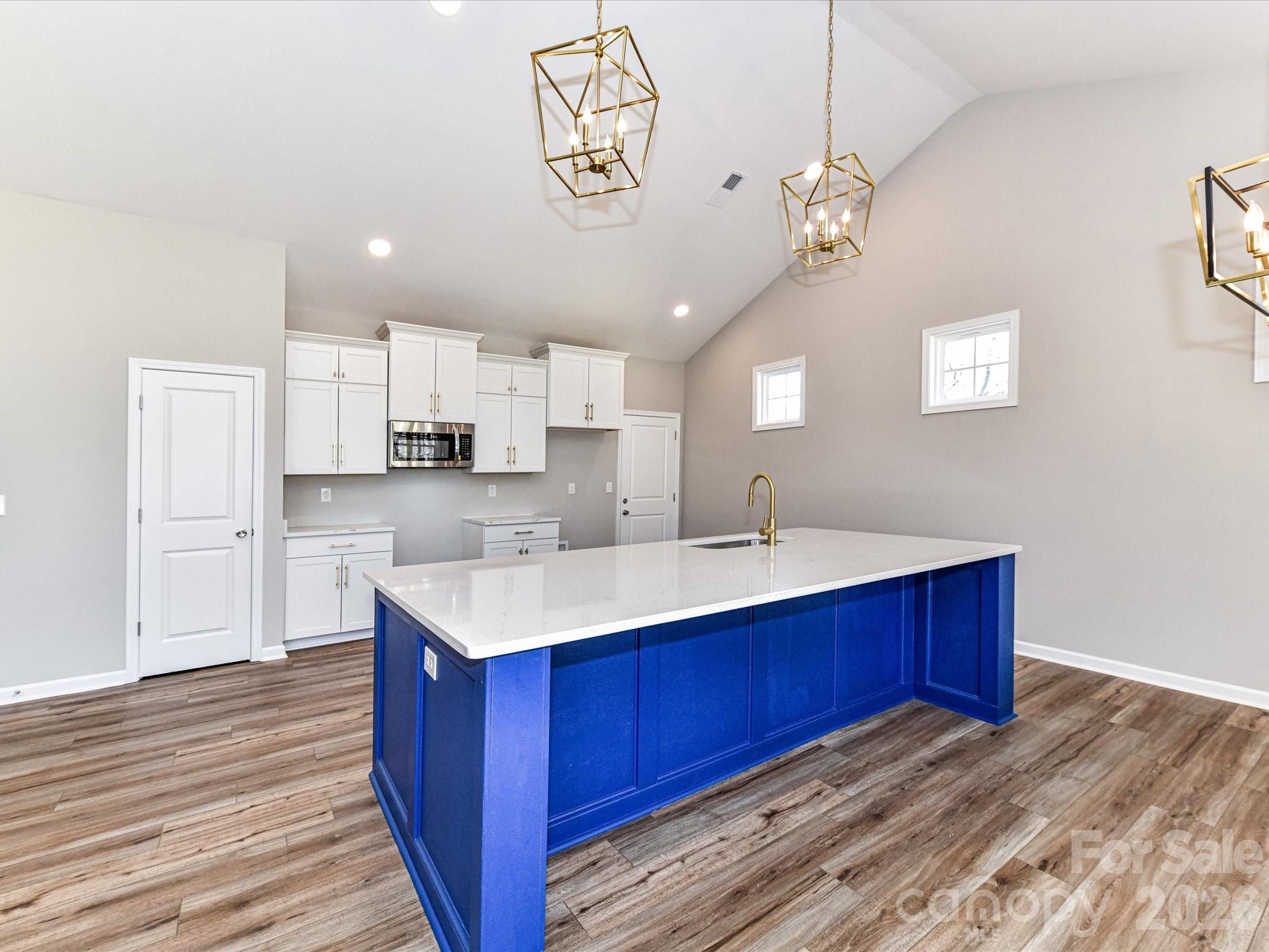 104 Poplar Street Clover, SC 29710 - Photo 13 of 33 a kitchen with a sink cabinets and wooden floor
