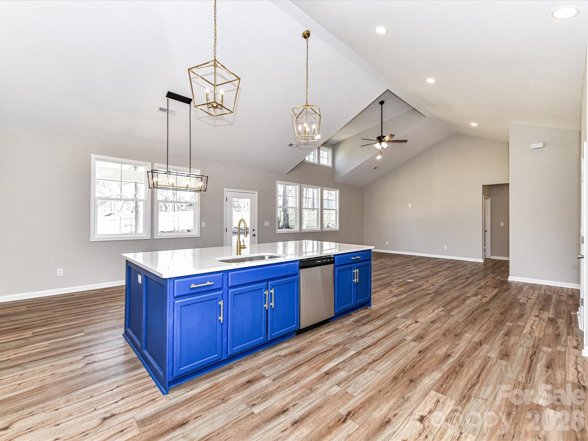 104 Poplar Street Clover, SC 29710 - Photo 15 of 33 a large kitchen with stainless steel appliances granite countertop a stove and wooden floor