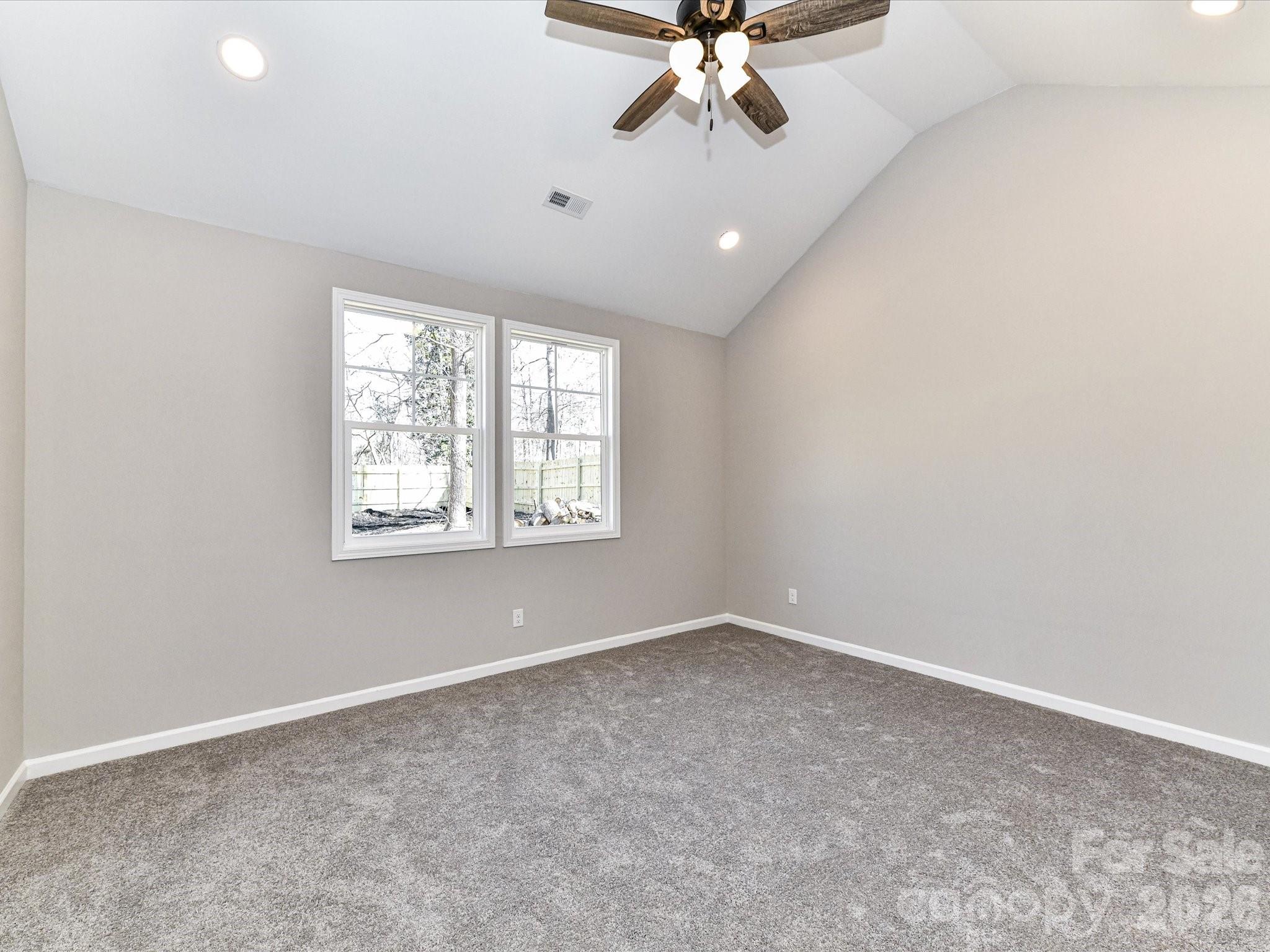 104 Poplar Street Clover, SC 29710 - Photo 16 of 33 an empty room with windows and fan