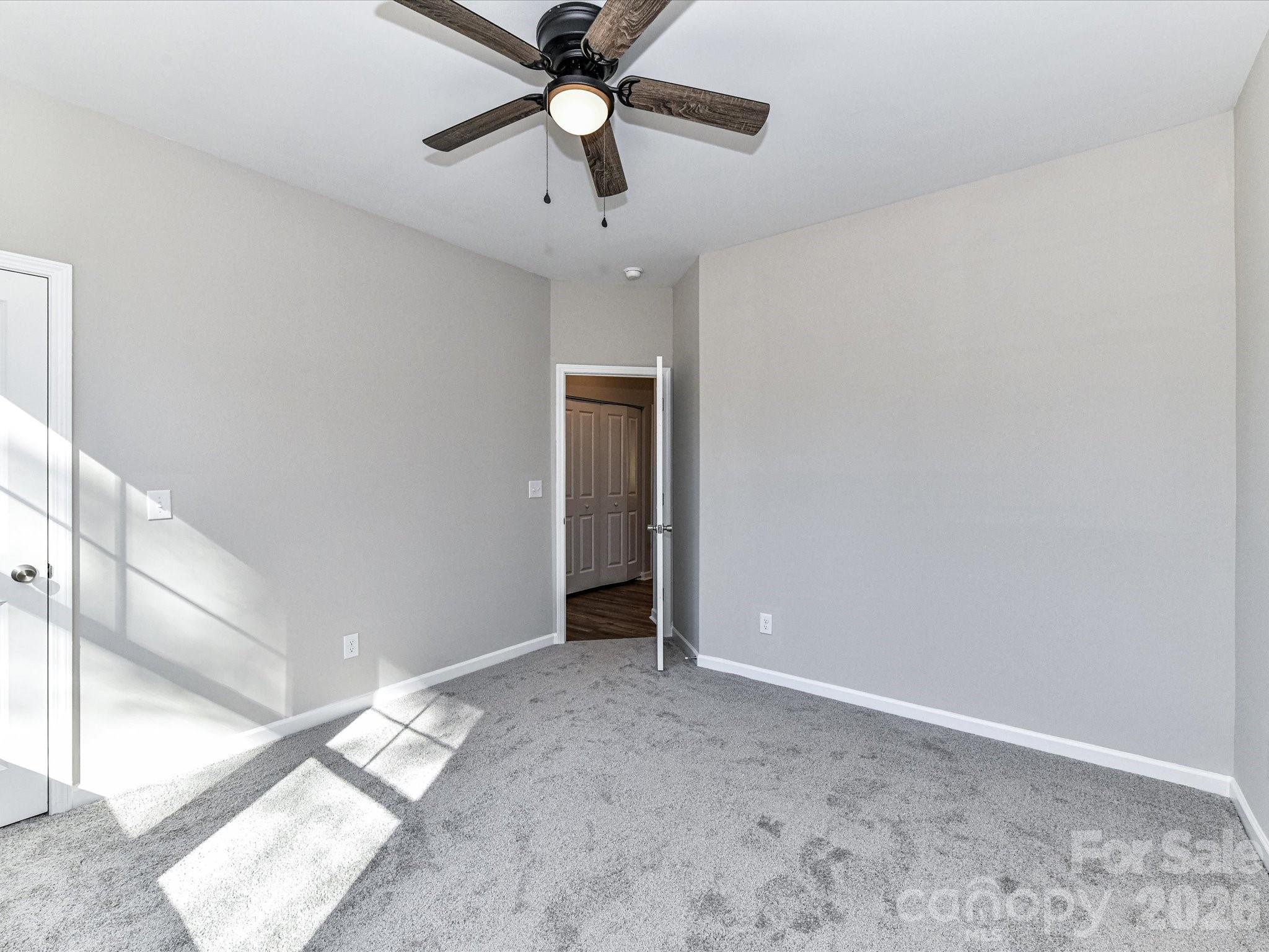 104 Poplar Street Clover, SC 29710 - Photo 28 of 33 an empty room with closet and a chandelier fan