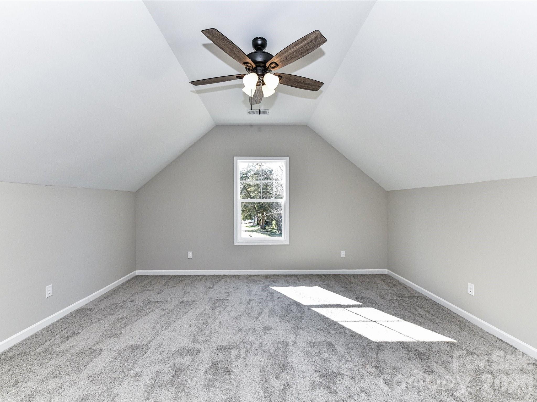 104 Poplar Street Clover, SC 29710 - Photo 30 of 33 an empty room with ceiling fan and window