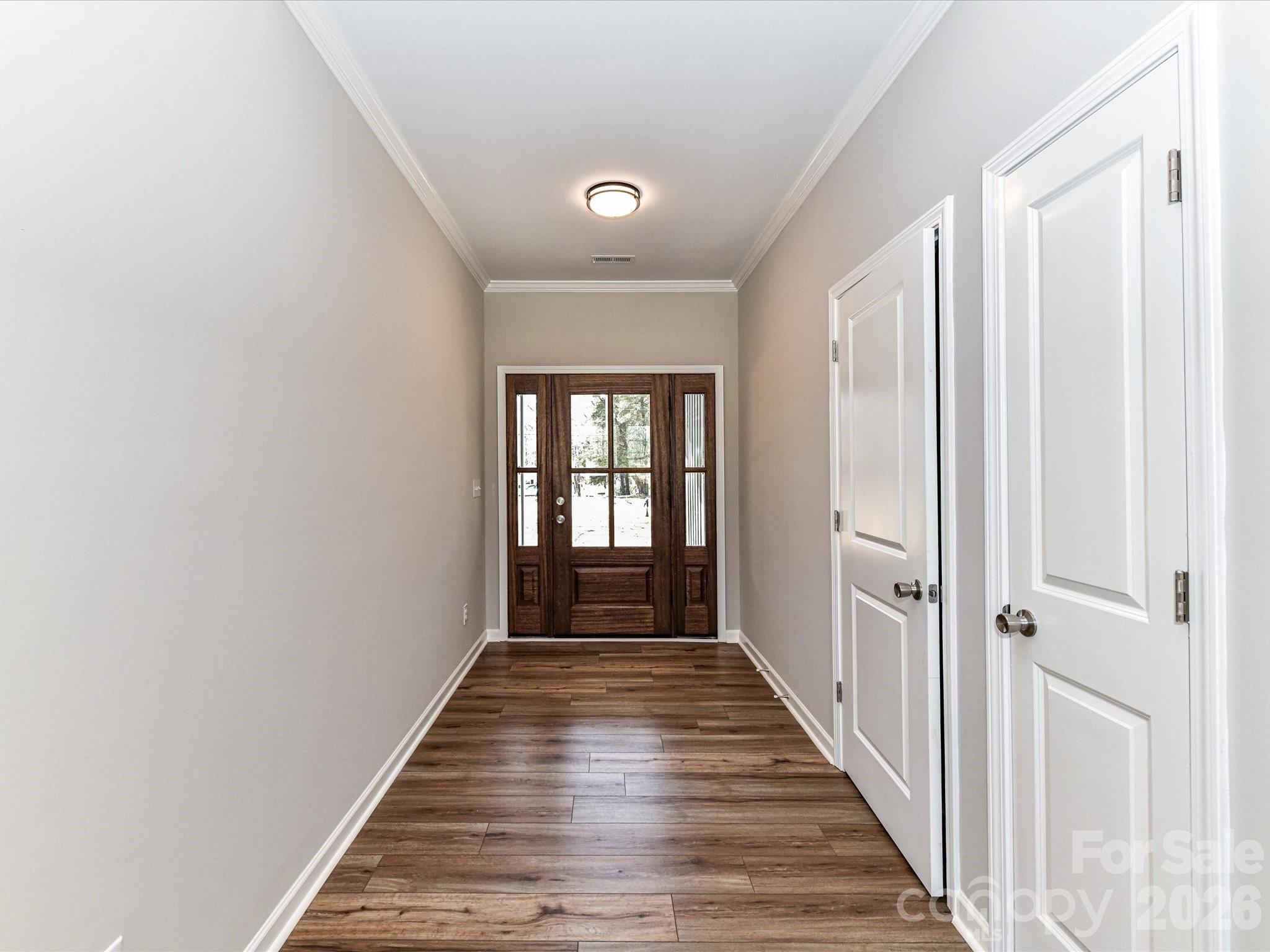 104 Poplar Street Clover, SC 29710 - Photo 4 of 33 a view of a hallway with wooden floor and staircase