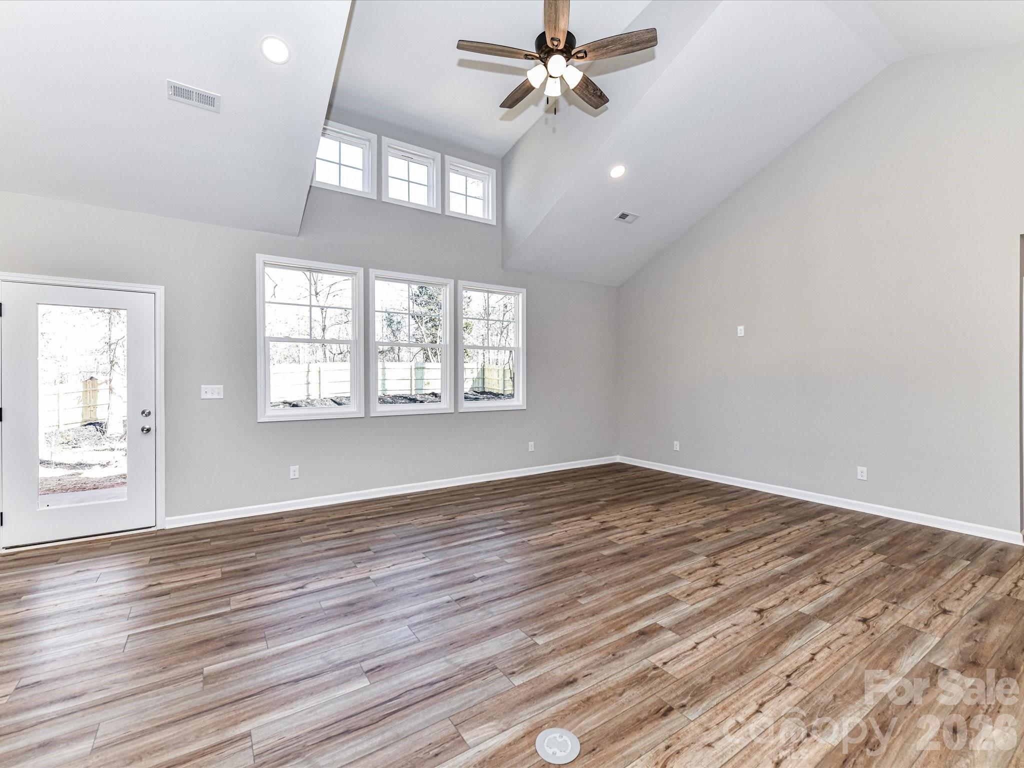 104 Poplar Street Clover, SC 29710 - Photo 5 of 33 wooden floor in an empty room with a window