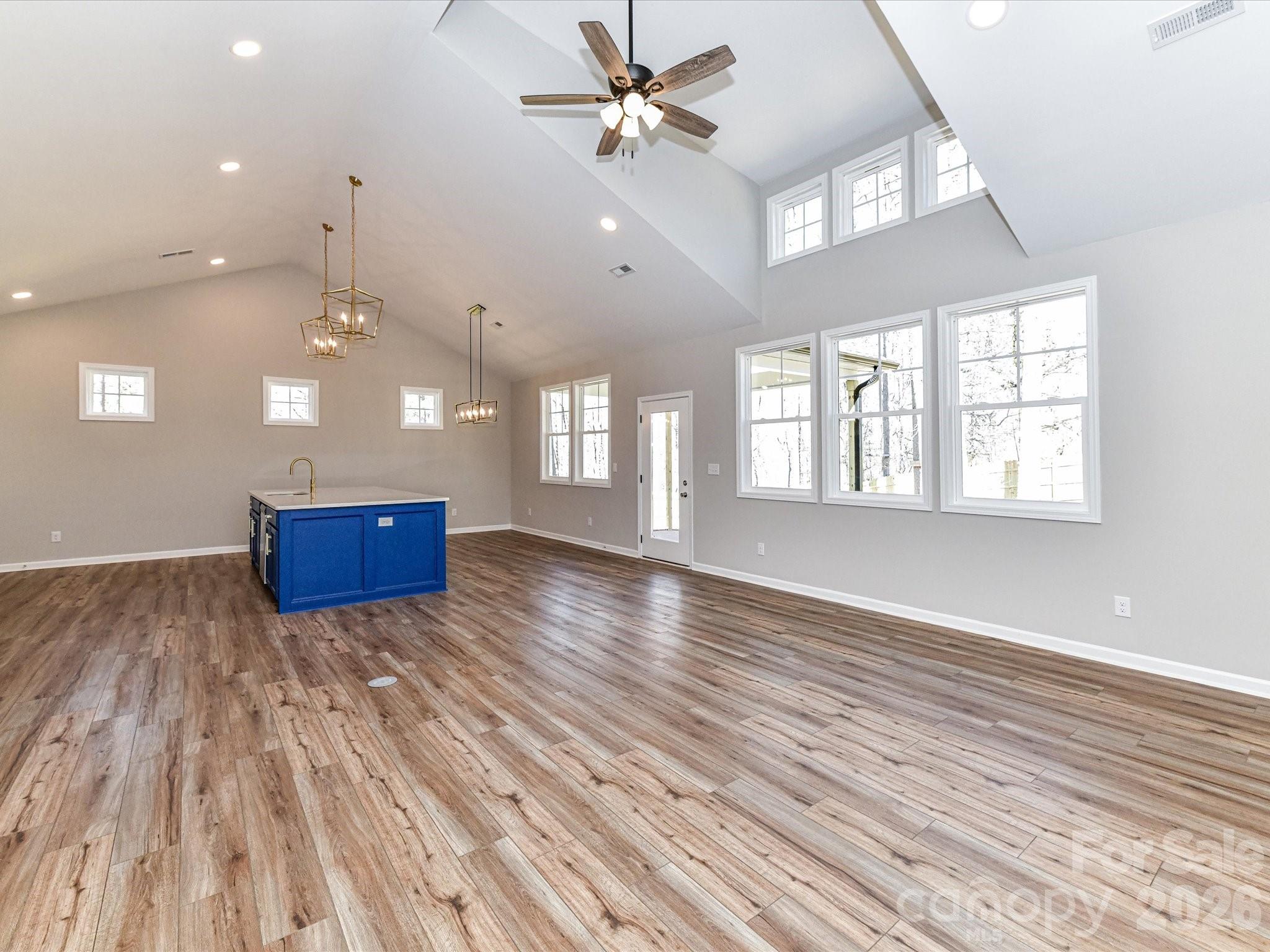 104 Poplar Street Clover, SC 29710 - Photo 9 of 33 an empty room with wooden floor and windows