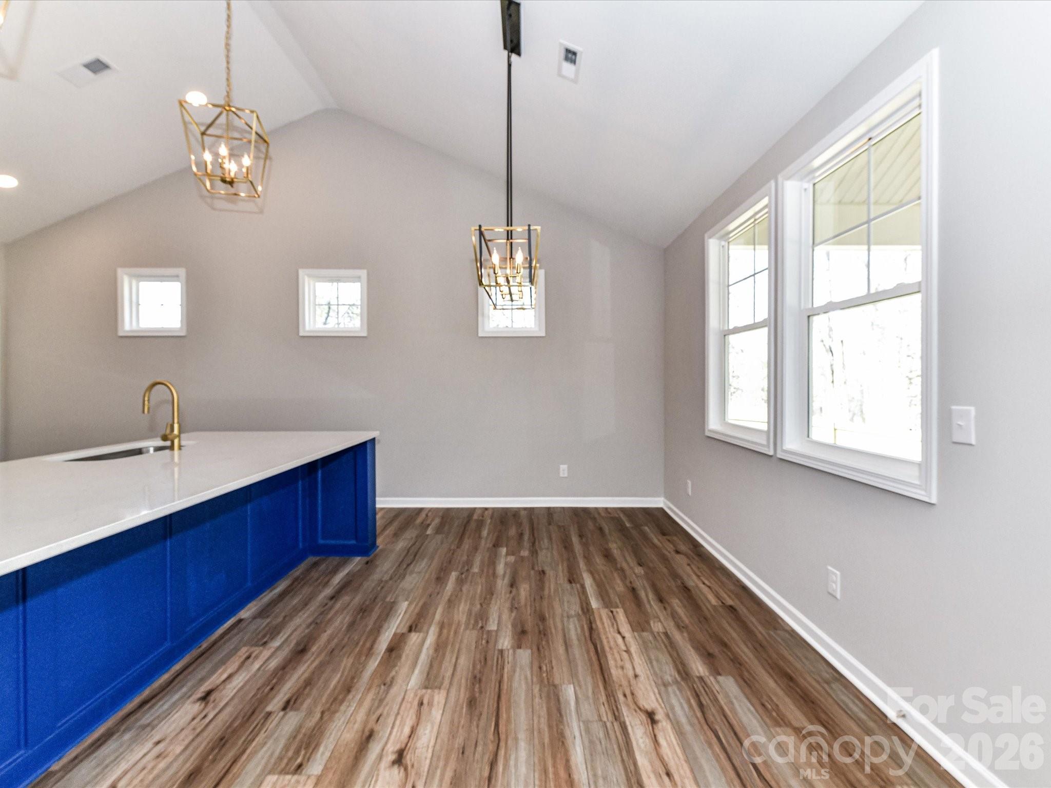 104 Poplar Street Clover, SC 29710 - Photo 10 of 33 a view of kitchen with wooden floor and windows