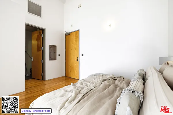 a view of bedroom with a bed and wooden floor