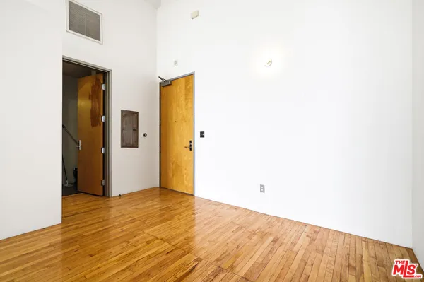a view of a room with wooden floor