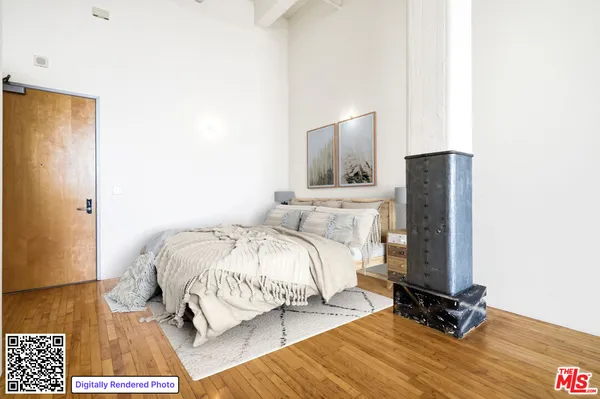 a bedroom with a bed and a mirror