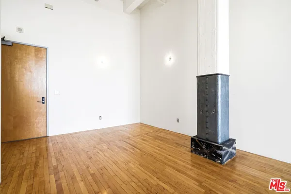 a view of a room with wooden floor