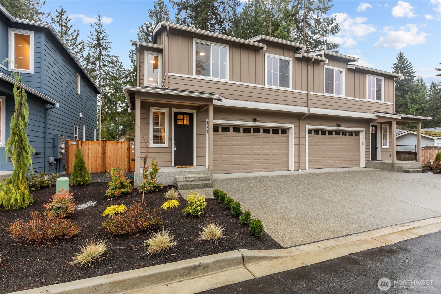 122 169th Place Southwest, Unit A Bothell, WA 98012 - Photo 1 of 29 a front view of a house with lots of potted plants