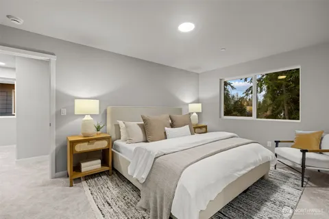 a bedroom with a bed and a large window