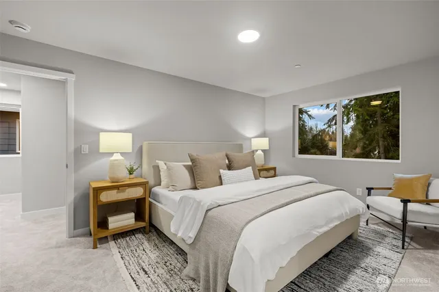 a bedroom with a bed and a large window