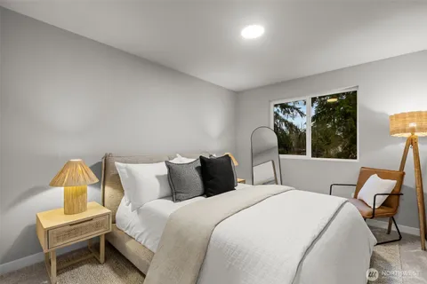 a bedroom with a bed and a lamp