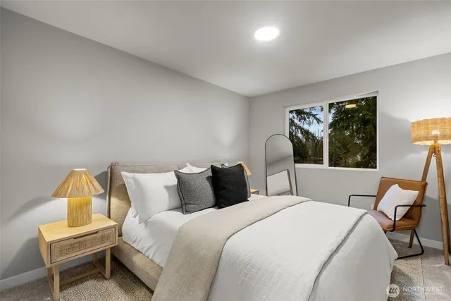 a bedroom with a bed and a lamp