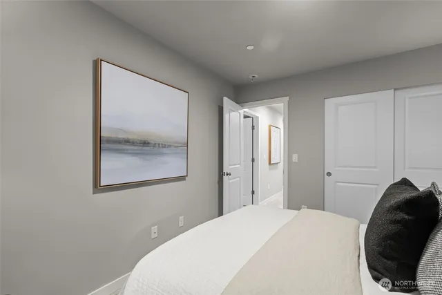 a bedroom with a bed and a couch with window