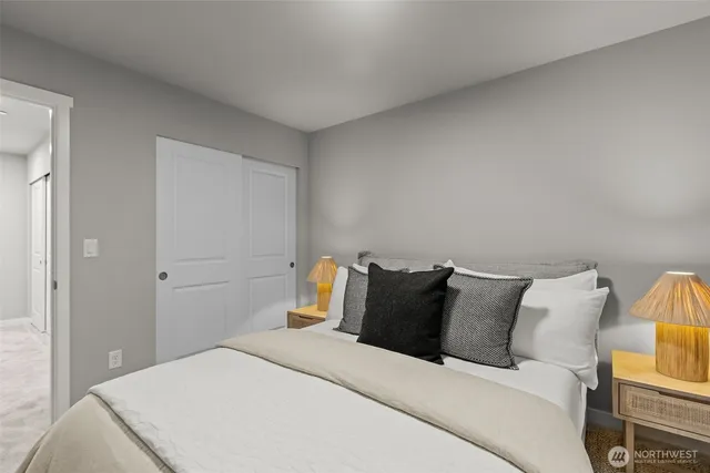 a bedroom with a bed and a potted plant