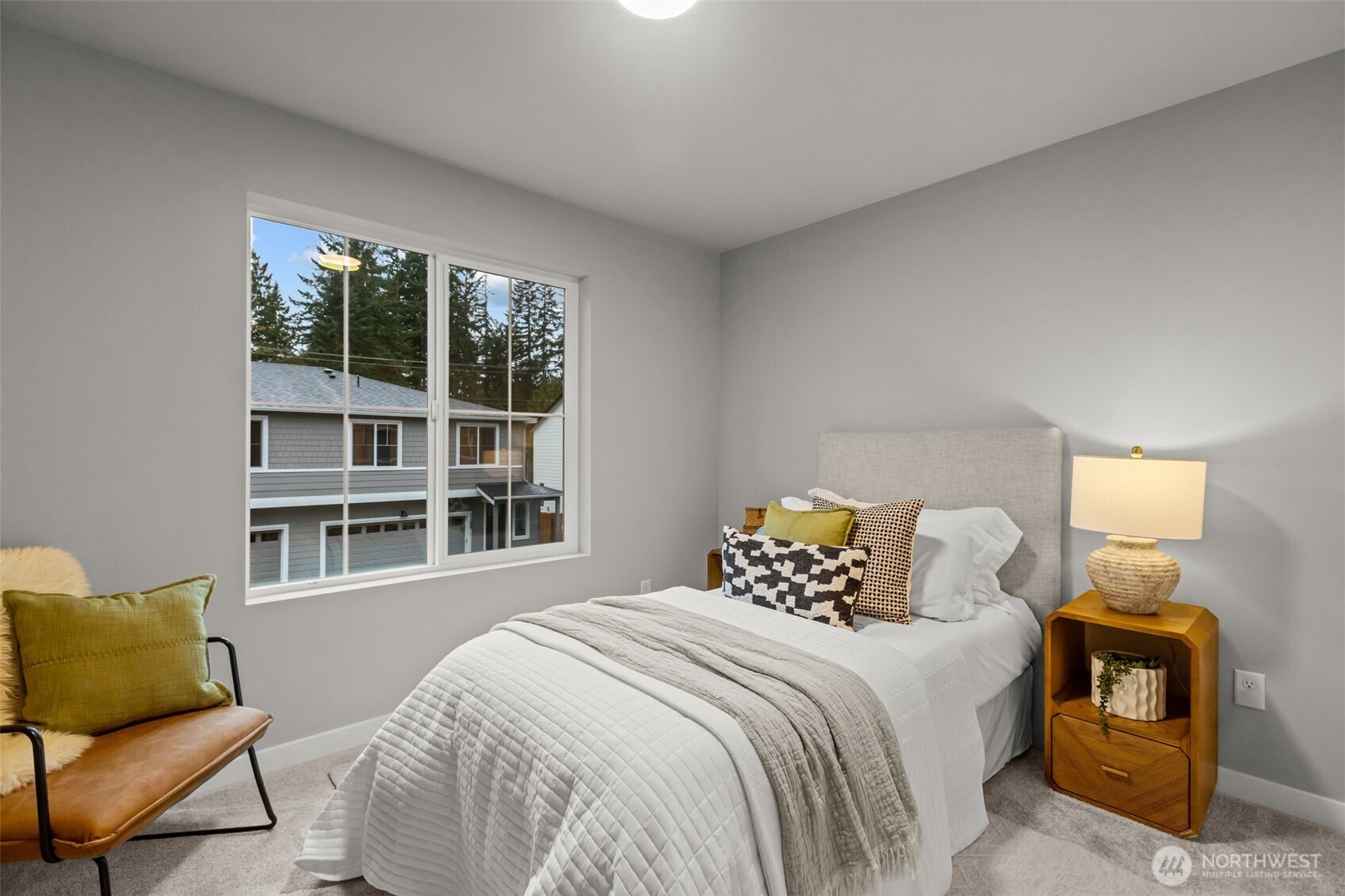 122 169th Place Southwest, Unit A Bothell, WA 98012 - Photo 24 of 29 a bedroom with a bed and a couch with window