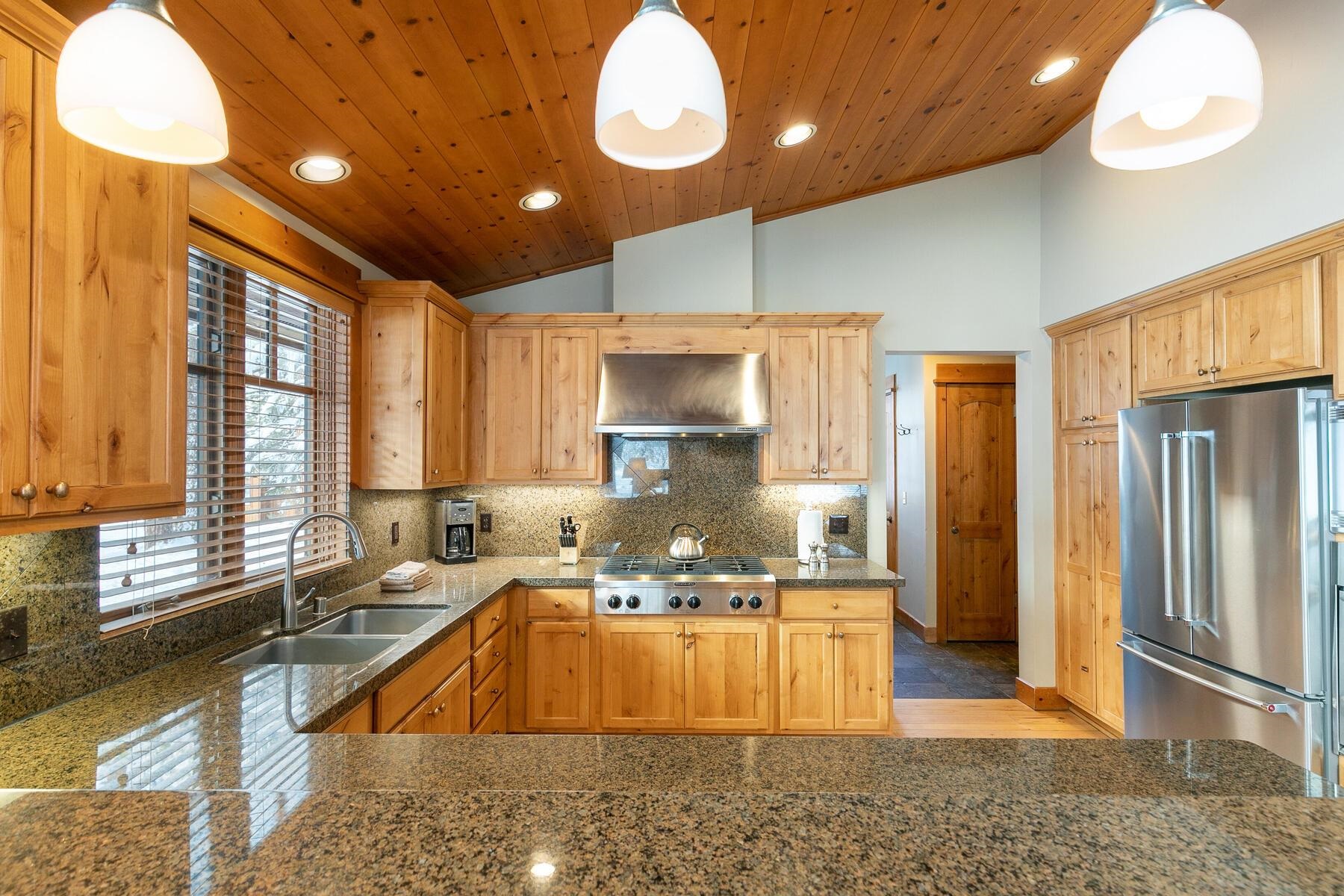 12483 Lookout Loop, Unit F187 Truckee, CA 96161 - Photo 20 of 26 a large kitchen with granite countertop a stove a sink and a refrigerator