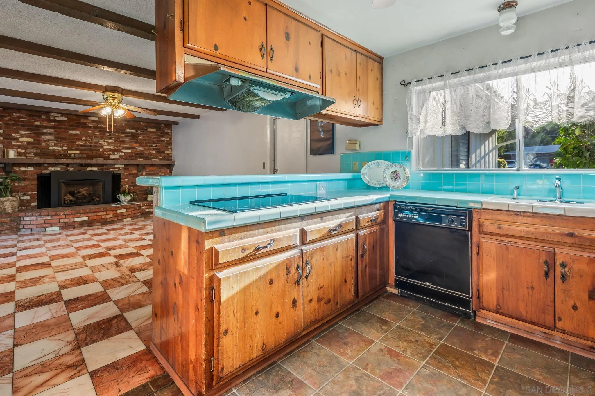5645 Severin Drive La Mesa, CA 91942 - Photo 12 of 29 a kitchen with stainless steel appliances granite countertop a stove a sink and a microwave